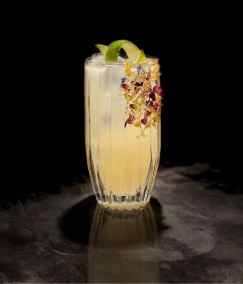 image of a yellow sour cocktail standing on a table